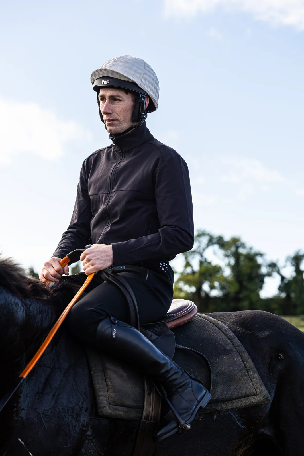 Rider wearing LMK racewear on horseback